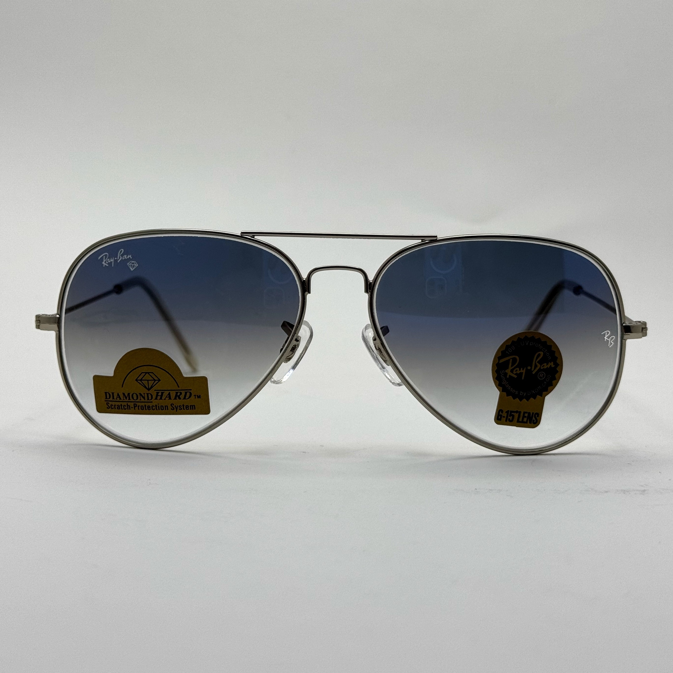 عینک ریبن خلبانی شیشه سنگ آبی هایلایت فریم نقره ای به همراه پک کامل ریبن کد Rayban RB 3025